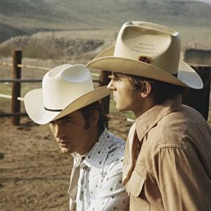 Young cowboys standing in ranch, close-up