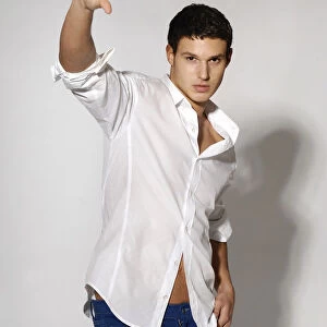 Young man in white shirt and blue jeans in movement