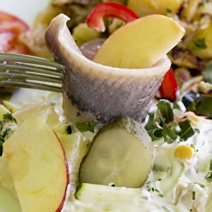 Young salted herring with yoghurt dressing, fruit and potatoes