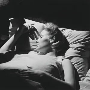 Young woman sleeping in bed (B&W)