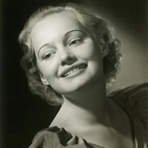 Young woman smiling, close-up, studio shot
