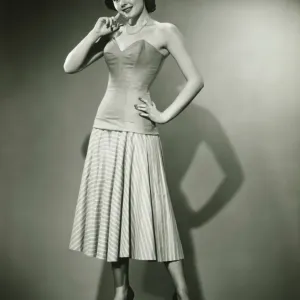 Young woman standing in studio, smiling, (B&W) Young woman standing in studio, smiling, (B&W)