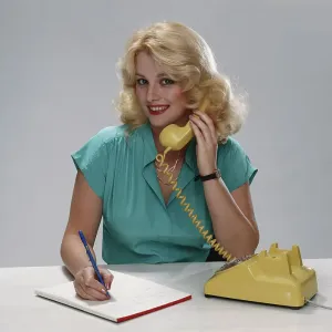 Young woman talking on phone, smiling, portrait