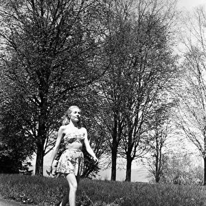 Young woman walking along country road