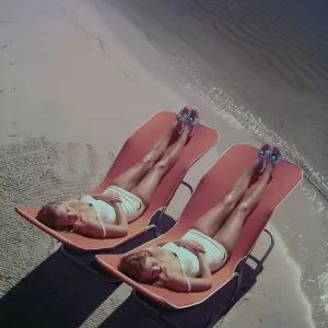 Two Young Women Lounging on the Beach Two Young Women Lounging on the Beach