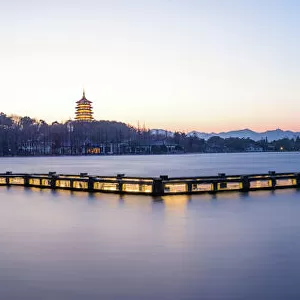 A zig zag bridge agsinst Leifeng Pagoda on the West Lake, Hangzhou