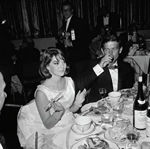 Prints of American actress Natalie Wood, accompanied by a man in a tuxedo and bow tie, dining at their table at the 12th Annual Deb Star Ball Grace, Glamour & Timeless Elegance: 12th Annual Deb Star Ball, Hollywood, L.A