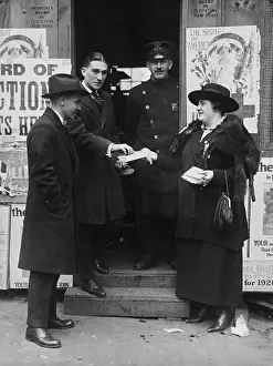 Prints of Suffragette Charlotte O'Connell giving out bonbons to a group of men at a polling station on the day of the 1918 New York state election, New York, US, 5th November 1918 Historic Moments from the Women’s Fight for the Vote: 1918 New York state election