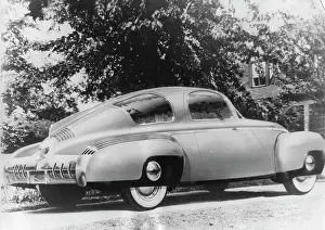 Prints of Heavily retouched photograph shows an illustration of the aerodynamic 1947 Tucker Torpedo automobile parked (in a photo) a driveway, August 1946. (Photo by PhotoQuest/Getty Images) Timeless Moments: A Visual Journey Through History’s Defining Images: 1947 Tucker Torpedo