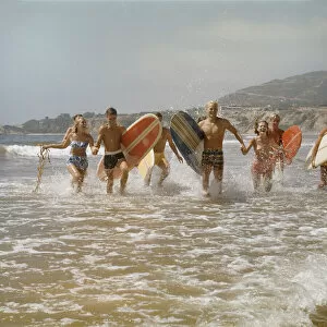Young Women Gallery: 1960s Surfers Running in the Water