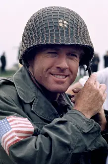 Prints of American actor Robert Redford is Major Julian Cook, puts on his helmet on the set of the 1977 drama film A Bridge Too Far, in Nijmegen, Gelderland, Netherlands, circa 1977 Robert Redford: Classic Hollywood Elegance: 1977 Movie A Bridge Too Far