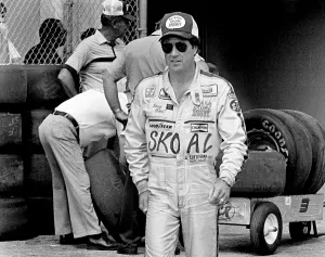 Prints of DAYTONA BEACH, FL - FEBRUARY 1983: NASCAR driver Harry Gant waks in the Daytona International Speedway garage area prior to the start of the 1983 Daytona 500 stock car race in Daytona Beach, Florida Full Throttle At Daytona Beach Prints: 1983 Daytona 500