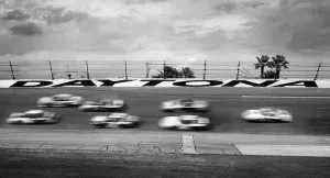 Prints of DAYTONA BEACH, FLORIDA - FEBRUARY 2003: NASCAR racecars speed around the track in a blur during the 2003 Daytona 500 stock car race at Daytona International Speedway in Daytona Beach, Florida Chasing Speed: Motorsport in Motion: 2003 Daytona 500