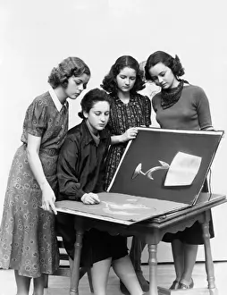 1930 Prints: 3 young women observe a fourth draw artwork in portfolio