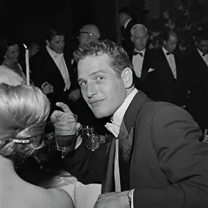 Prints of American actor Paul Newman, who wears a tailcoat jacket and a white bow tie, a drinking glass in his right hand, attends the 30th Academy Awards Grace, Grit & Golden Moments: 30th Academy Awards