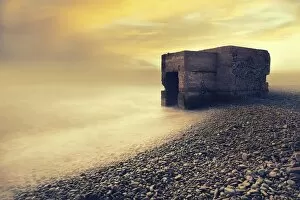 Abandoned bunker on the beach at sunrise