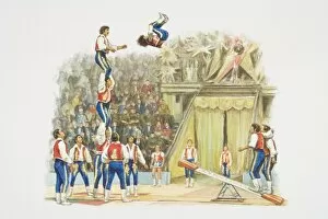 Acrobats performing in circus ring, jumping on springboard to form human pyramid, audience in background