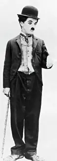 Prints of (Original Caption). Charlie Chaplin in typical hobo attire with hat and cane Master of Mime, Icon of Cinema: Chaplin in Prints: Actor Charlie Chaplin in Costume