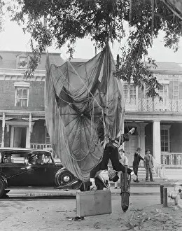 Actor Harold Lloyd Hanging from a Parachute Outdoors