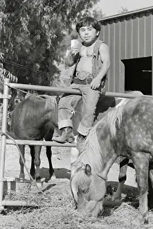 Actor Herve Villechaize Straddling Fence with Horses Nearby