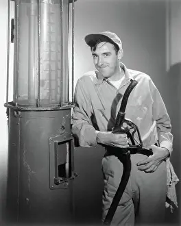 Actor Jim Nabors Holding Gas Station Hose