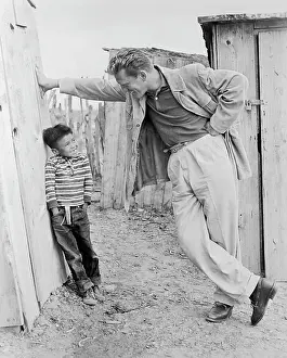 Actor Kirk Douglas Talking with Young Boy in Rural Movie Scene