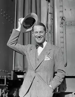 Actor Maurice Chevalier Removing His Hat and Smiling