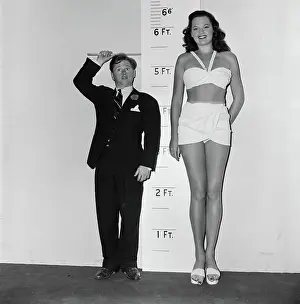 Actor Mickey Rooney Measuring His Costar