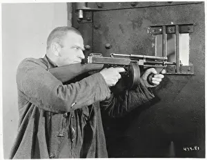 Actor Wallace Beery Aiming Gun