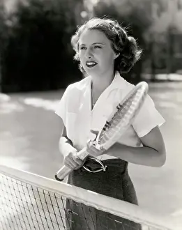 Actress Barbara Stanwyck Playing Tennis