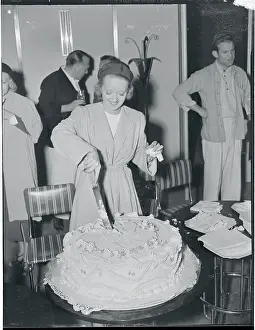 Actress Bette Davis Cutting Large Cake