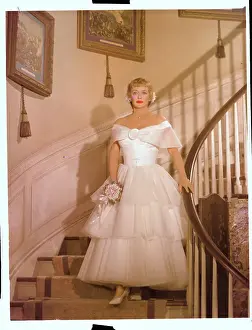Actress Bette Davis in Formal Dress and Standing on Stairs