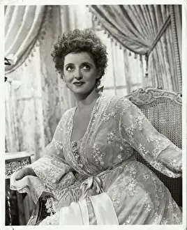 Delicate Prints: Actress Bette Davis in Lacy Loungewear and Sitting on Sofa