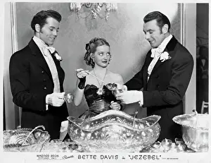 Prints of (Original Caption). Henry Fonda, Bette Davis, and George Brent are shown in a scene from the picture Jezebel, returning to Chicago at the United Artists Theater, Wednesday, January 14th Timeless Moments: Henry Fonda Through the Lens: Actress Bette Davis and Male Costars in Table Scene From Jezebel