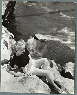 Landforms Prints: Actress Bette Davis Sitting on Rocks Above Water