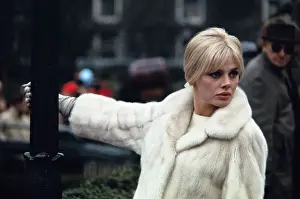 Actress Britt Ekland Wearing White Fur Coat and Pointing