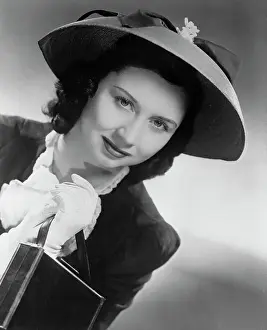 Actress Dorothy Kilgallen Posing in Hat and Holding Purse