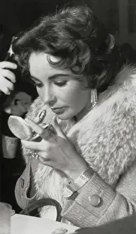 Fur Collar Prints: Actress Elizabeth Taylor Applying Lipstick
