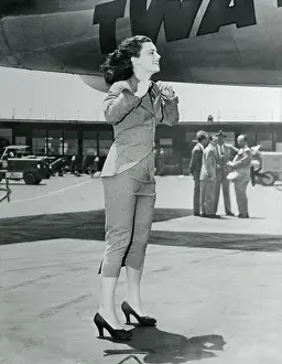 Passenger Airplane Prints: Actress Faith Domergue Catching Breeze from Airplane