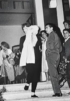 Shyness Prints: Actress Greta Garbo Hiding Her Face While Exiting Restaurant