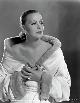 Prints of (Original Caption). USA: Greta Garbo, Metro-Goldwyn Mayer Timeless Elegance: The Iconic Greta Garbo Collection: Actress Greta Garbo Wearing White with Pulled Back Hairstyle