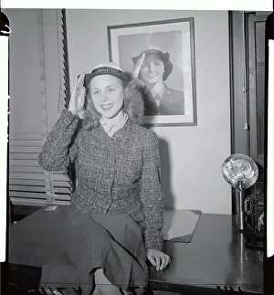 Actress Joan Carter Mortimer Sitting on Desk