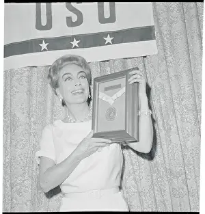 Actress Joan Crawford Holding Woman of the Year Trophy