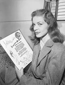 Award Prints: Actress Lauren Bacall Holding Plaque