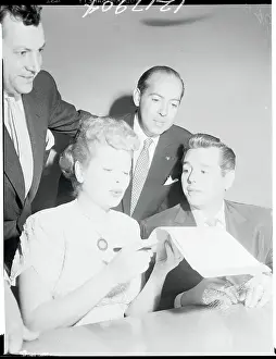 Actress Lucille Ball and Desi Arnaz Examining Advertisement Contract