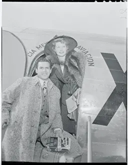 Prints of (Original Caption). The place shown is the Grand Central Airport in Glendale, California, as filmsters, and husband and wife team, Desi Arnaz and Lucille Ball leave for the Mexico City Movie Festival Behind the Laughter: Lucille Ball's Unseen Moments: Actress Lucille Ball and Desi Arnaz Standing at Airplane Entrance
