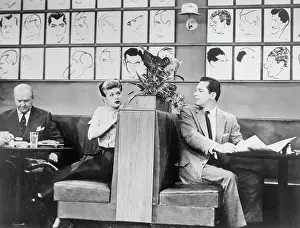 Actress Lucille Ball Turning to Gaze at Actor William Holden in Booth