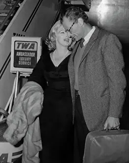 Actress Marilyn Monroe Whispering into Husbands Ear