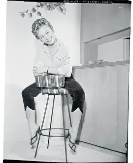 Actress Mitzi Gaynor Posing on Stool