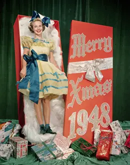 Actress Mona Freeman Posing as Christmas Gift